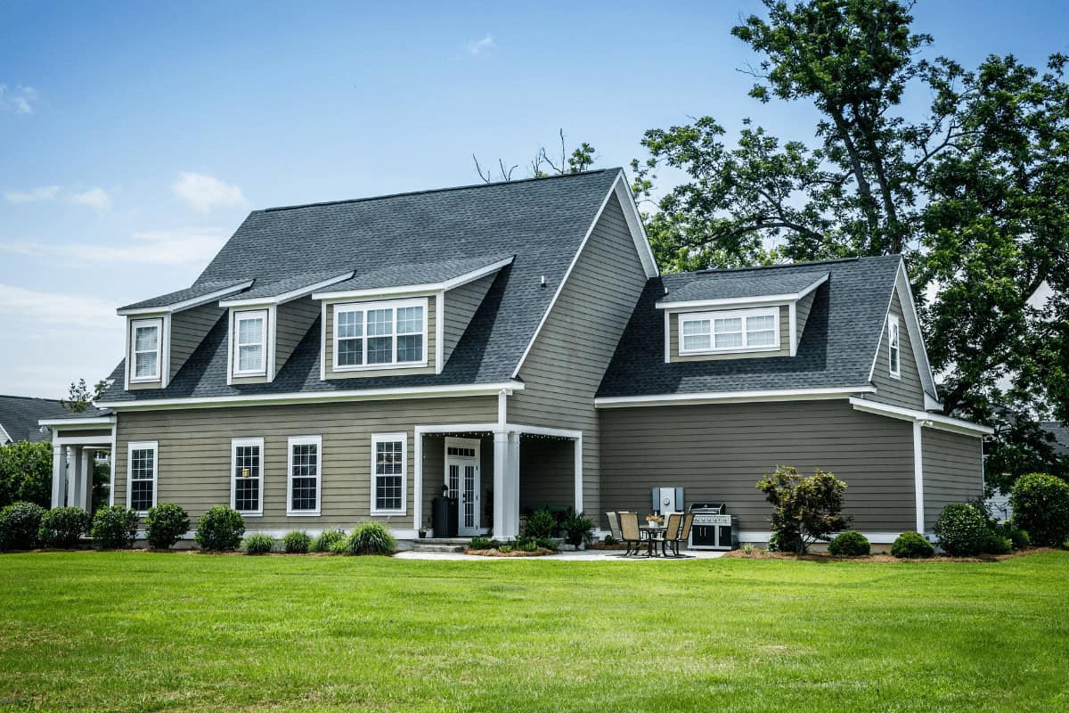 A modern home shows a Cornerstone Metals roof that looks strong and stylish. The house appears safe and welcoming.