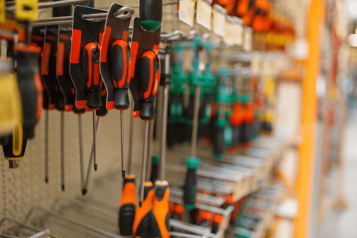 Cornerstone Metals screwdrivers are organized in a row on a display, showing the brand’s wide tool selection for metal roofing projects.
